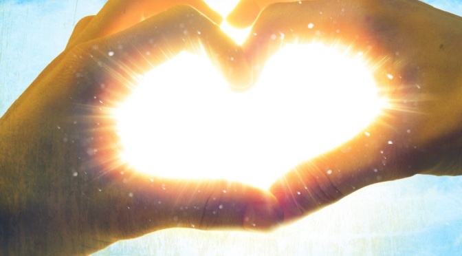 hands_making_love_heart_with_shining_light